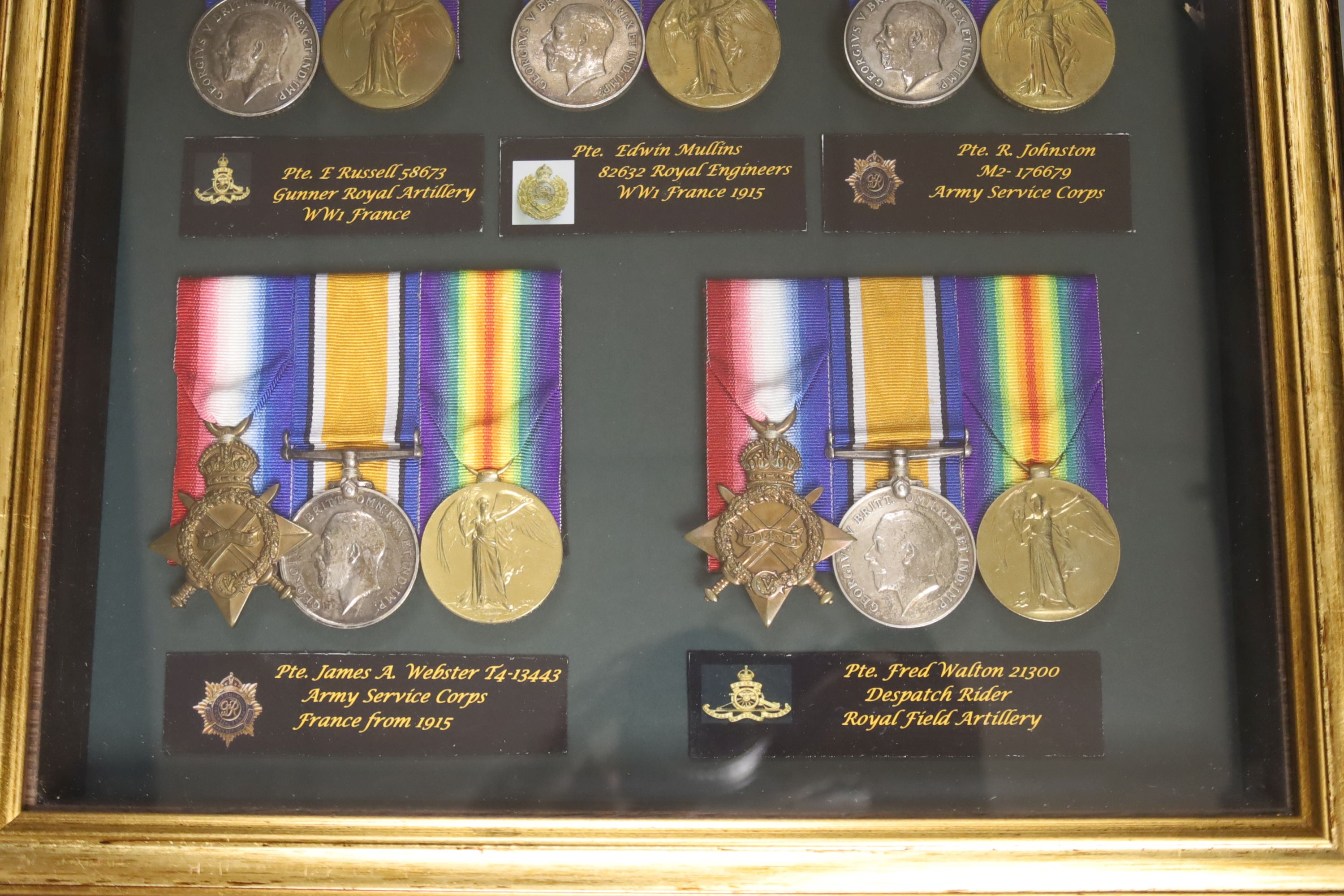 Five WW1 medal groups in one display case